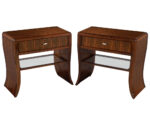 Two curved wood nightstands featuring a single drawer, chrome hardware, and a lower mirrored shelf for display.